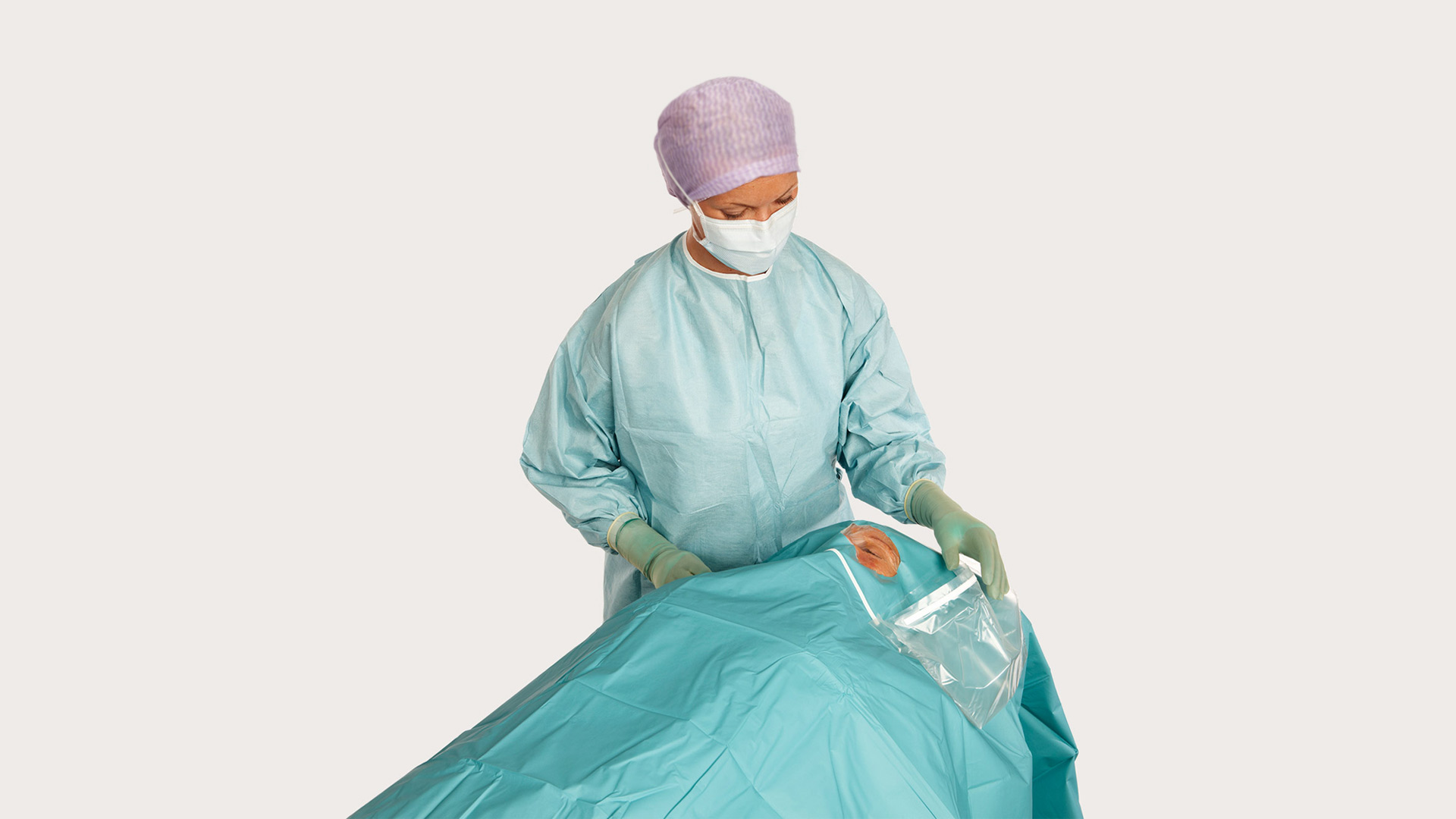 a female surgeon using BARRIER ophthalmic drapes used on a patient