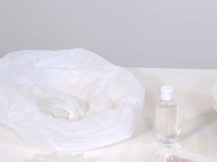 A photo of a plastic bag and a bottle of hand sanitiser. 