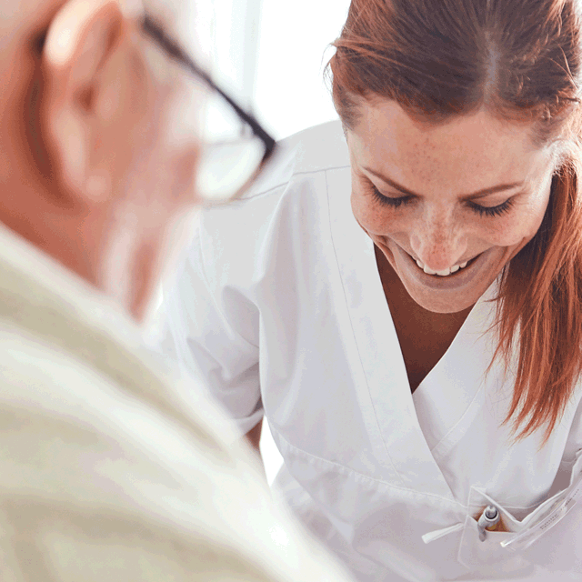 A photo of a nurse being happy together with a patient.