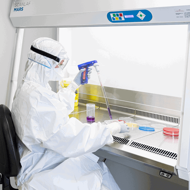 A photo of a person working in a medical lab.