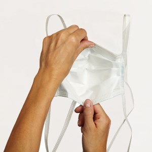 Hand unfolding the surgical mask pleats 