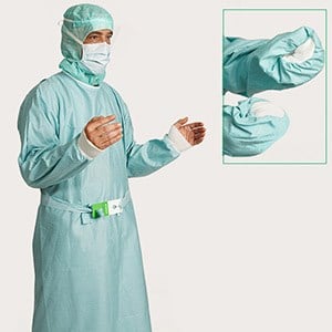 Healthcare professional demonstrating step 3 of gown donning