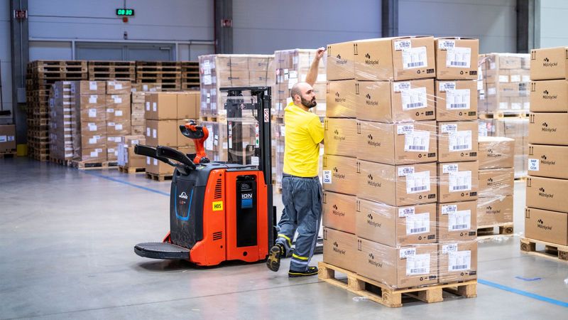 Factory worker organising and preparing packaged supplies